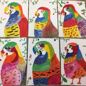 Parrots painted by children at holiday club, at Arty Amber